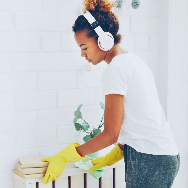 women cleaning a shelf